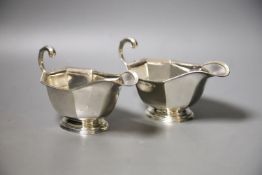 A pair of 1930's silver sauceboats, with flying scroll handles, 16.2cm, 8oz.