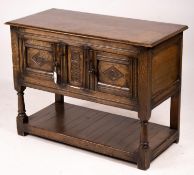 An 18th century style oak two door low cupboard, width 106cm, depth 50cm, height 78cm