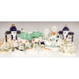 A collection of Victorian Staffordshire pottery to include a sponge glazed seated cat, a pair of