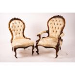 A late Victorian carved walnut three piece salon suite, comprising chaise longue, open armchair