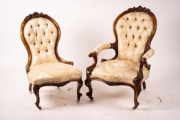 A late Victorian carved walnut three piece salon suite, comprising chaise longue, open armchair