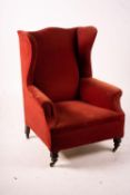 A late Victorian upholstered wing armchair, width 76cm, depth 70cm, height 100cm