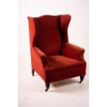 A late Victorian upholstered wing armchair, width 76cm, depth 70cm, height 100cm