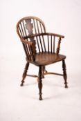 A mid 19th century yew and elm Windsor elbow chair with crinoline stretcher, width 54cm, depth 46cm,