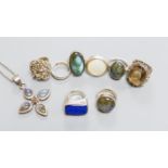 Six assorted white metal and gem set dress rings, a white metal band and dress ring and a white