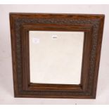 An early 20th century carved oak rectangular wall mirror, width 57cm, height 64cm