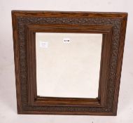 An early 20th century carved oak rectangular wall mirror, width 57cm, height 64cm