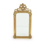 A 19th century French carved giltwood and gesso wall mirrorwith arched plate and ripple moulded