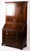 A George III oak bureau cabinet, width 108cm, depth 52cm, height 209cm