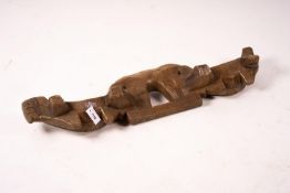 A 19th century Spanish carved fruitwood ox yoke, length 108cm