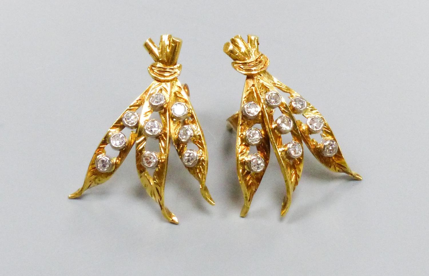 A pair of modern yellow metal and nine stone diamond chip set triple leaf earrings, 20mm, gross