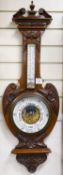 An Edwardian carved walnut cased aneroid barometer and thermometer, height 99cm