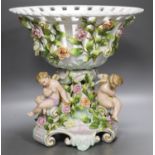 A Plaue porcelain Meissen style fruit stand, encrusted with flowers and winged amorini30.5cm