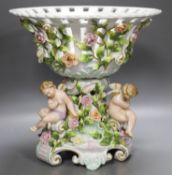 A Plaue porcelain Meissen style fruit stand, encrusted with flowers and winged amorini30.5cm