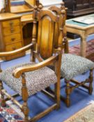 A set of ten 18th century style panelled oak dining chairs, two with arms