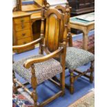 A set of ten 18th century style panelled oak dining chairs, two with arms