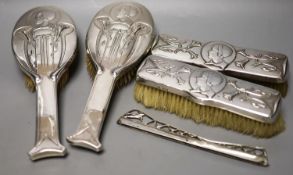 An Edwardian Art Nouveau silver mounted brush and comb set (a.f.), by William Hutton & Sons, London,