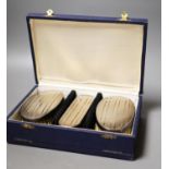 A modern cased silver mounted three piece brush set.