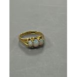 A late Victorian 18ct gold and claw set three stone white opal ring, size M, gross weight 4.1