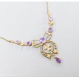 An Edwardian 9ct, amethyst and seed pearl set drop pendant necklace, 44cm,gross weight 4.3 grams.