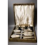 A late 1940's cased silver mounted eight piece dressing table set with atomiser, scent bottle and