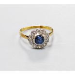 A yellow metal, sapphire and diamond cluster set flower head ring, size G, gross weight 1.6 grams.