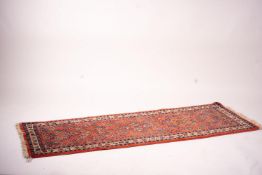 A Persian red ground runner, 202 x 83cm