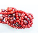 A group of loose simulated cherry amber beads and one other similar necklace, gross weight 254