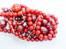 A group of loose simulated cherry amber beads and one other similar necklace, gross weight 254