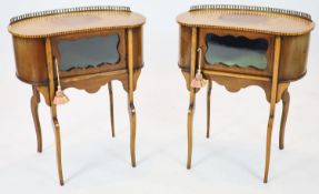 A pair of Edwardian inlaid mahogany kidney shaped side cabinets, each fitted with a central glazed