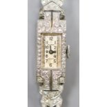 A white metal (stamped All platinum) and diamond set manual wind cocktail watch, on a 9ct white