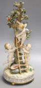 A German porcelain Meissen style group of amorini, climbing a ladder to pick fruit from a tree,