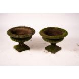 A pair of weathered reconstituted stone campana garden urns, Diam.56cm H.42cm