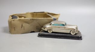 A Prameta clockwork Mercedes Benz 300, with base, 16cm long, instructions and remnants of box
