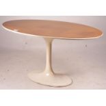 An Arkana style tulip base teak top oval dining table, length 152cm, depth 91cm, height 76cm