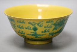 A Chinese yellow ground sgraffito’dragon’ bowl, Kangxi mark but later15cm diameter