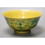 A Chinese yellow ground sgraffito’dragon’ bowl, Kangxi mark but later15cm diameter