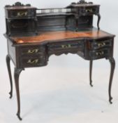 A late Victorian carved mahogany serpentine-shaped writing desk, length 106cm, depth 54cm, height