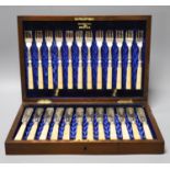 An Edwardian cased set of twelve pairs of ivory handles silver fish eaters, Walker & Hall,