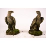 A pair of weathered reconstituted stone eagle garden ornaments, H.54cm