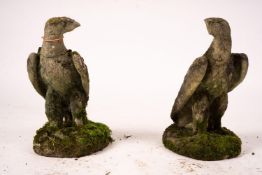 A pair of weathered reconstituted stone eagle garden ornaments, H.54cm