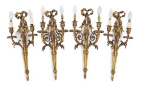 Two pairs of Adam Revival ram's mask head motif wall lightswith ribbon tied crests and acanthus