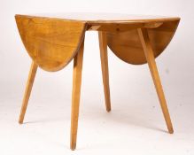 An Ercol light elm and beech circular drop leaf dining table, length 124cm extended, width 113cm,