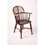 A 19th century yew and elm Yorkshire area Windsor elbow chair with crinoline stretcher, width