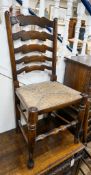 A set of eight Titchmarsh & Godwin elm and beech ladderback rush seat chairs, two with arms