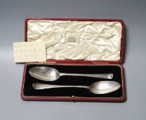 A cased matched pair of 18th century silver Hanovarian rat tail pattern tablespoons, one date for