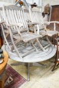 An Alexander Rose circular weathered teak garden table, diameter 144cm, height 71cm, (no bolts)