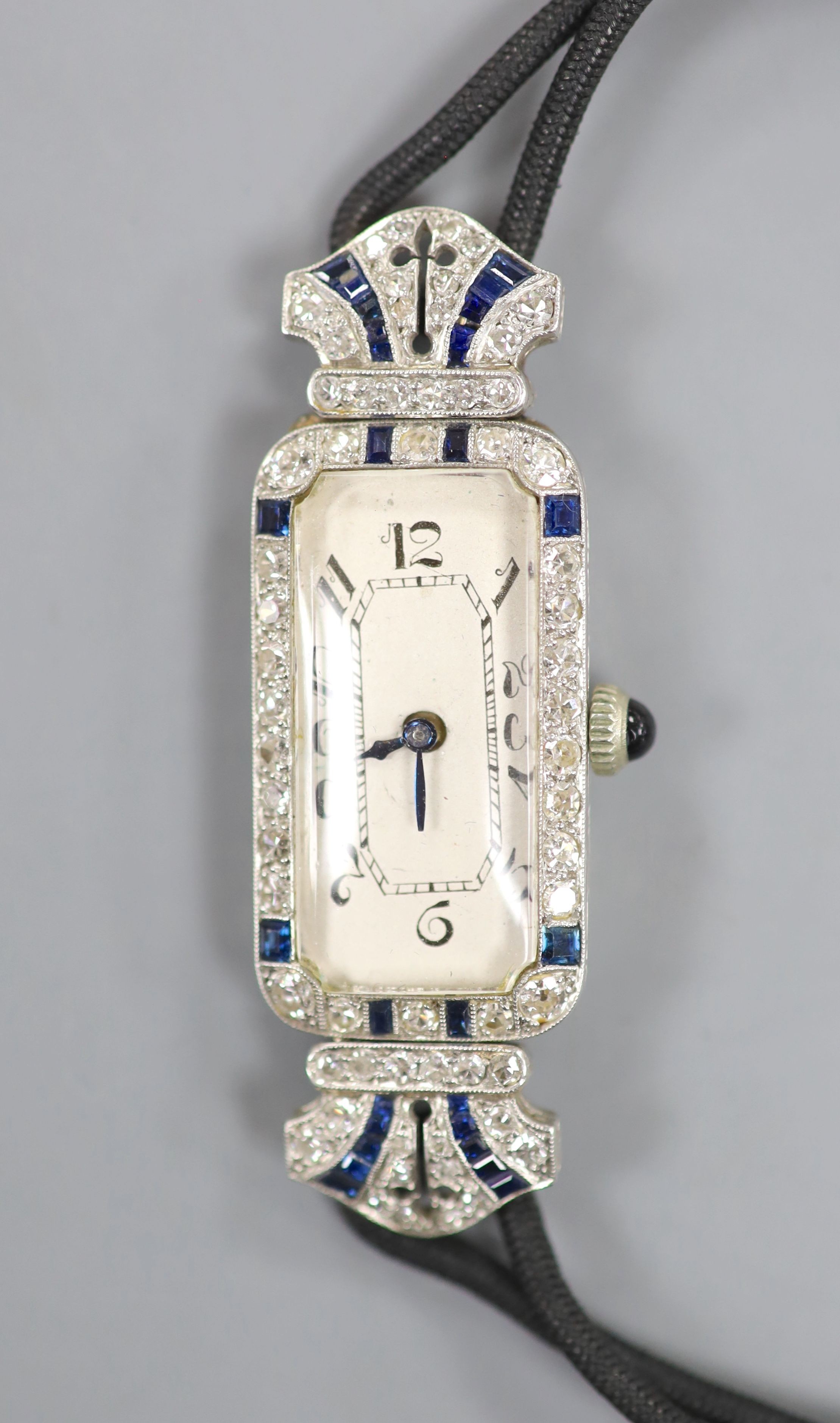 A lady's 1920's/1930's yellow and white metal, synthetic? sapphire and diamond set cocktail watch,