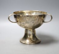A George V Art Nouveau planished silver tri-handled pedestal bowl, by William Hutton & Sons Ltd,