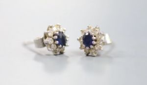 A small modern pair of 18ct white gold, sapphire and diamond cluster set ear studs, 7mm, gross